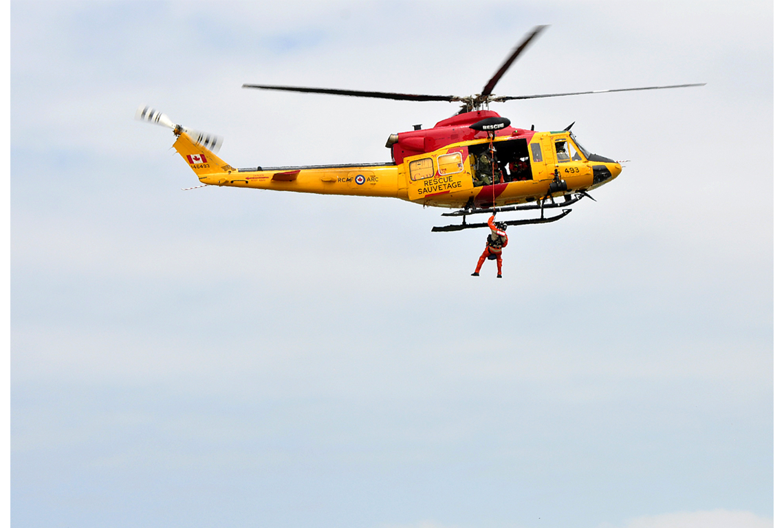 Canadian armed forces members helping with a search and rescue