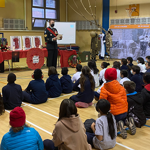 Children listening to a veteran