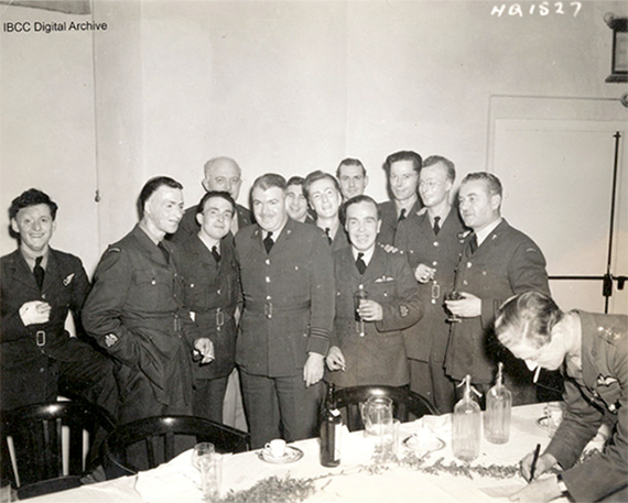 Twelve airmen standing around Group Captain Albert Ross Tilley