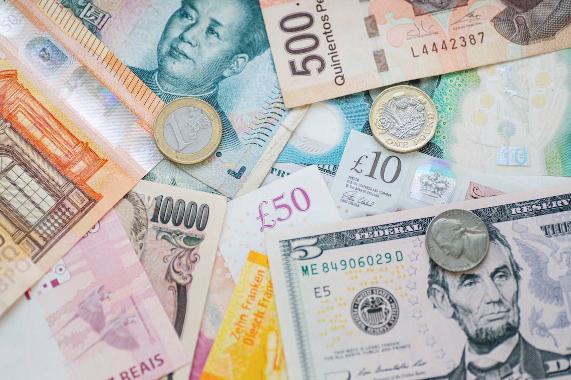 A variety of bills and coins from different currencies around the world